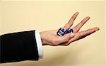 A woman holding a pair of blue dice