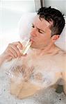 Man relaxing in bathtub with bubbles