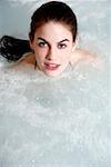 Young woman in jacuzzi at a spa
