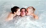 One man with two women  in jacuzzi at a spa