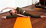 Young woman performing a pilates stretch