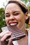 Young woman eating chocolate