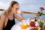 Young woman having breakfast on hotel terrace