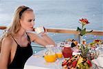 Young woman having breakfast on hotel terrace