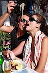 Man feeding spaghetti to woman in a restaurant