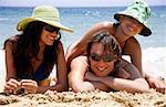 One man and two women on the beach