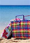 Beach bag with towel on beach