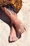 Woman's bare feet on sand