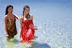 Two young women posing in water
