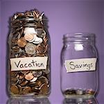 Two glass jars with change labeled Education and Savings