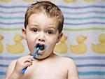 Boy brushing teeth in bathroom