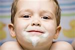 Boy smiling with toothpaste on face