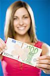 Woman with torn one hundred dollar euro banknote with plastic strips