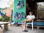 Man sitting in chair and smiling outdoors with diving masks