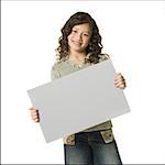 Girl with braces holding blank sign smiling