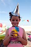 Girl Holding Drink at Birthday Party