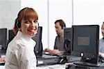 Business People Working at Computers with Headsets