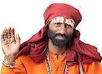 Portrait of a sadhu raising his hand as a blessing