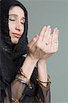 Close-up of a young woman praying