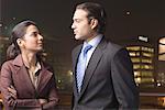 Businessman and a businesswoman looking at each other