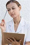 Close-up of a female nurse holding a clipboard