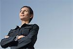 Low angle view of a businesswoman standing with her arms crossed