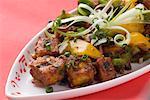 Close-up of stir fried cottage cheese cubes on a platter