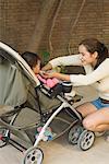 Young woman looking at her baby and smiling