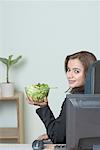 Portrait of a businesswoman holding a bowl of salad
