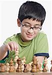 Close-up of a boy playing chess