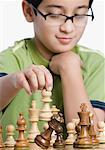 Close-up of a boy playing chess