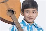 Portrait of a boy holding a mandolin