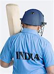 Rear view of a boy holding a cricket bat