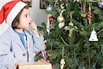 Close-up of a boy looking at a Christmas tree