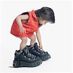 Side profile of a boy wearing oversized hiking boots