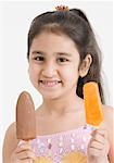 Portrait of a girl holding two ice creams