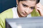 Close-up of a businesswoman thinking in front of a computer