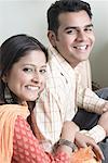 Portrait of a young couple sitting and smiling