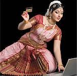 Young woman holding a credit card and using a laptop