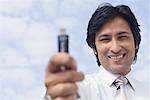 Portrait of a businessman holding a USB pen drive