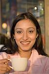 Portrait of a businesswoman holding a coffee cup and smiling