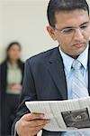 Close-up of a businessman reading a newspaper