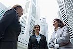 Low angle view of three businesswomen talking to each other