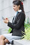 Businesswoman using a personal data assistant