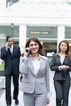 Businesswoman talking on a mobile phone and smiling