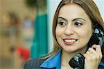 Close-up of a businesswoman talking on a pay phone
