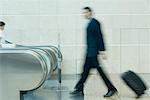 Blurred view of a businessman carrying his luggage