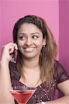 Close-up of a young woman talking on a mobile phone and smiling