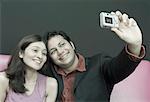 Young couple taking a photograph of themselves