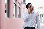 Mid adult man talking on a mobile phone and looking up